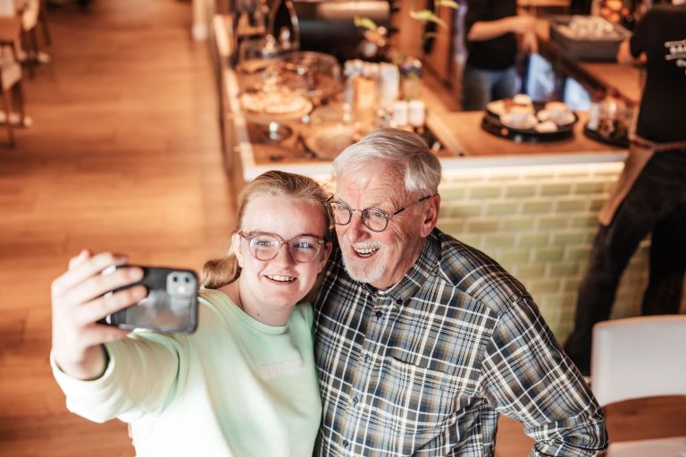 Jongere vrouw en oudere man maken selfie